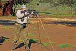 Photo of Sue with rifle and shooting sticks